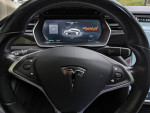 Interior view of a 2014 Tesla Model S 85 showcasing the touchscreen and steering wheel.