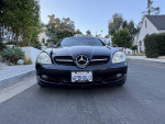 Front view of a 2008 Mercedes-Benz SLK350 convertible parked on a residential street