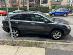 2008 Lexus RX400h hybrid in Smoky Granite Mica parked on the street with two sets of tires.