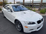 2012 white BMW M3 convertible parked with tinted windows and a sleek design, showcasing its sporty features.