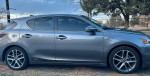 Side view of a gray 2015 Lexus CT 200h showcasing its sporty design and alloy wheels.