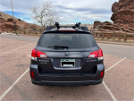Rear view of a 2013 Subaru Outback parked, showcasing its sporty design and ready for adventure.