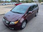 2016 burgundy Honda Odyssey SE minivan with 95000 miles, features including power sliding doors and DVD system.