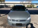 Front view of a 2009 Chevrolet Impala LT in gray color, showcasing its sleek design and features.