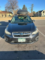 Front view of a 2012 Subaru Impreza 2.0i AWD hatchback parked with snow tires and Yakima skybox.