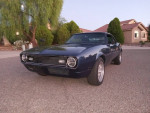 1968 Chevrolet Camaro with new paint and V8 engine for sale, showcasing its sleek design on a suburban street.
