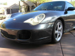 2004 Porsche 911 Carrera 4S coupe in Atlas Grey Metallic with 18" Sport Techno wheels and black leather interior.