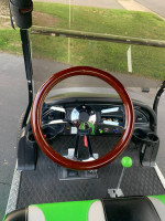 Interior view of a rebuilt Club Car Precedent golf cart with a stylish wooden steering wheel.