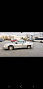 2003 Chevrolet Monte Carlo for sale, silver color, parked with summer tires, showing minor body damage.