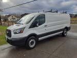 2016 Ford Transit Cargo Van with EcoBoost engine, in white, parked on a driveway with green grass.