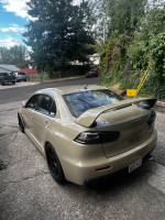 2011 Mitsubishi Evo X GSR with upgrades parked on a residential street.