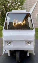Front view of a mobile bar tap truck with a 'Cheers!' sign, perfect for events and parties.