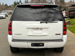 Rear view of a 2007 GMC Yukon Denali AWD, showcasing its sleek design and chrome details.