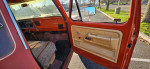 Interior view of a classic 1976 Ford F250 Highboy truck showcasing the dashboard and seat.