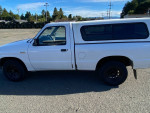 White Mazda B2300 pickup truck with a clean title and a check engine light issue for sale
