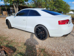 2013 Audi A5 Quattro in white with black wheels parked on gravel, showcasing its sleek design.