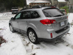 2010 Subaru Outback parked in snowy terrain, showcasing its premium features and all-wheel drive capabilities.