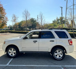 2012 Ford Escape Hybrid in white, parked in a sunny outdoor location with trees and clear sky.