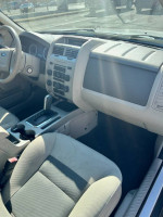 Interior view of a 2008 Ford Escape with clean seats and dashboard, excellent condition.