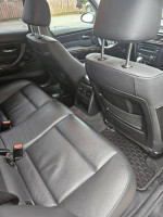 Interior view of a 2007 BMW 335i twin turbo with black leather seats and modern dashboard features.