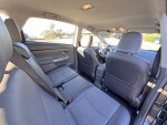 Interior view of a 2012 Toyota Prius V5 showing spacious leather seats and a clean layout.