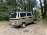 1987 Volkswagen Vanagon parked in nature, showing its unique design and classic features.