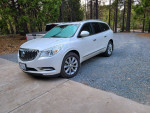 2016 Buick Enclave in white frost tricoat, parked in a forested area, with excellent service records.