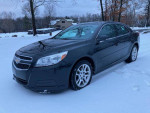 2013 Chevrolet Malibu LT in snowy landscape, low mileage of 43,000, great for commuting and families.