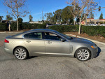 2010 Jaguar XF parked on the street, showcasing its sleek design and clean body with minimal wear.