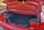 Trunk of a red 2007 Ford Mustang GT convertible with ample storage space and clean interior.