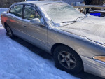 2000 Buick LeSabre parked in snow, driven 190,000 miles, with new tires and battery.