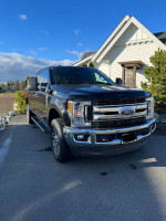 2018 Ford F350 XLT FX4 truck with 97,370 kms parked in front of a house