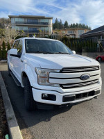 2018 Ford F150 Lariat FX4 in white with black leather interior, parked in a driveway.