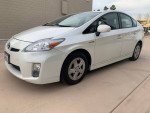 2011 Toyota Prius in white with alloy wheels, showcasing fuel efficiency and modern design