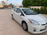 2011 Toyota Prius with 56,000 miles, featuring alloy wheels and Bluetooth, parked in a scenic location.