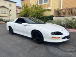 1997 Chevrolet Camaro Z28 in mint condition, white exterior, black wheels, parked in residential area