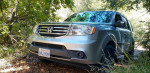 2013 Honda Pilot parked in nature, showcasing its 4WD and family-friendly features.