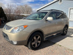 2007 Hyundai Veracruz SUV with clean title and new parts, parked outside under clear sky.