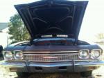 Front view of a 1968 Chevrolet Chevelle with hood open, showcasing classic design and details.