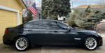 2013 BMW 750Li xDrive in black, showcasing its sleek design and long wheelbase for enhanced rear legroom.