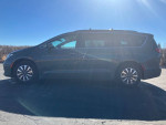2021 Chrysler Pacifica Hybrid Limited FWD parked, showcasing its sleek design and spacious family seating.