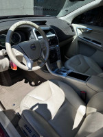 Interior view of a 2011 Volvo XC60 with leather seats and modern dashboard features