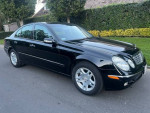 2004 Mercedes-Benz E320 Luxury black sedan with leather interior parked on a driveway, low mileage, well-maintained.