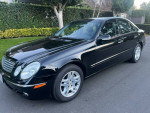 2004 Mercedes E320 luxury sedan in black with leather interior, low mileage and well-maintained condition.
