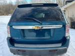 Rear view of a blue 2007 Chevrolet Equinox LT parked in snowy conditions