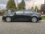 Side view of a black 2020 Toyota Corolla Hybrid, ideal for driving schools or daily use, with leather seats and backup camera.