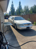 2004 Lincoln Town Limo parked, featuring a white exterior and spacious interior, ideal for Disney trips.