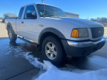 2002 Ford Ranger extended cab 4x4 parked, showing front and side view on a snowy ground.