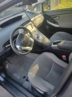 Interior view of a 2013 Toyota Prius with clean upholstery and modern dashboard controls.