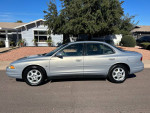 1999 Oldsmobile Intrigue GL in good condition parked on a street, showcasing its sleek profile and clean exterior.